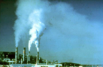 Large smokestacks releasing pollutants